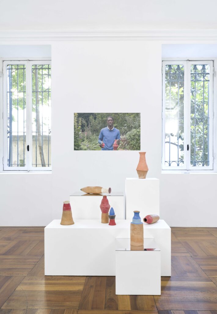 Marguerite Kahrl, Underground Conversations 2024 terra cotta and colored slip, variable dimensions (foreground), Relational Portraits, video, 2024, 5 minutes (background)